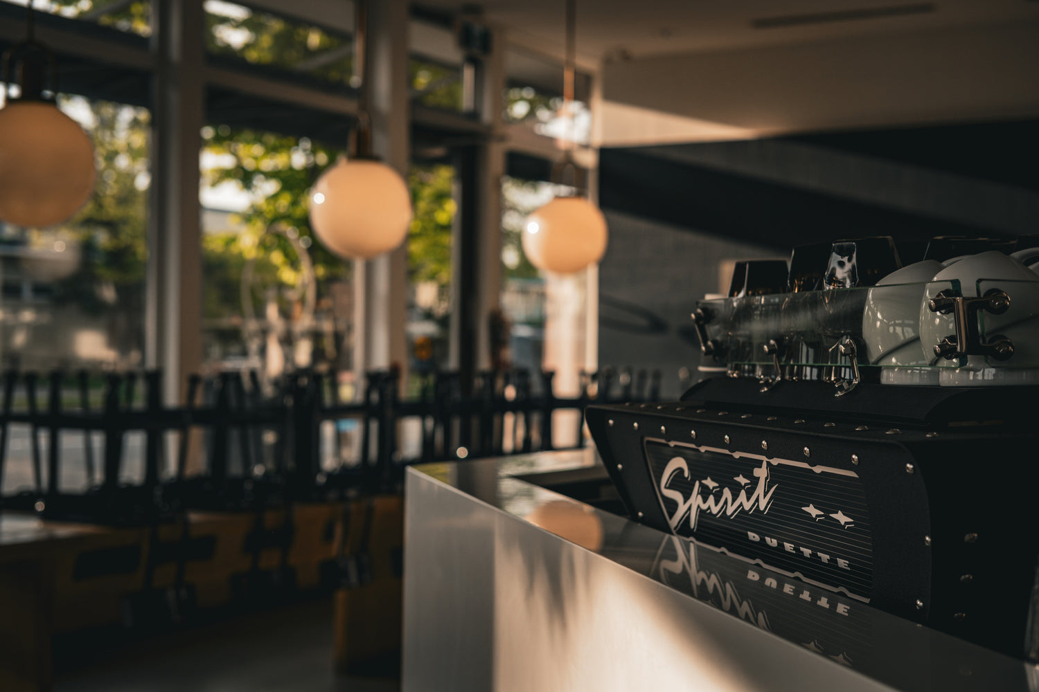 Coffee machine with 'Spirit' branding in a modern cafe setting